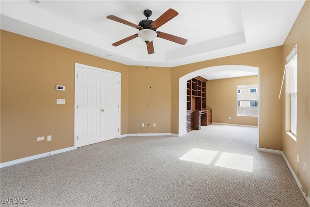 248 Hyssop Ct, Henderson, NV 89015 - carpeted empty room with arched walkways, ceiling fan, baseboards, and a raised ceiling