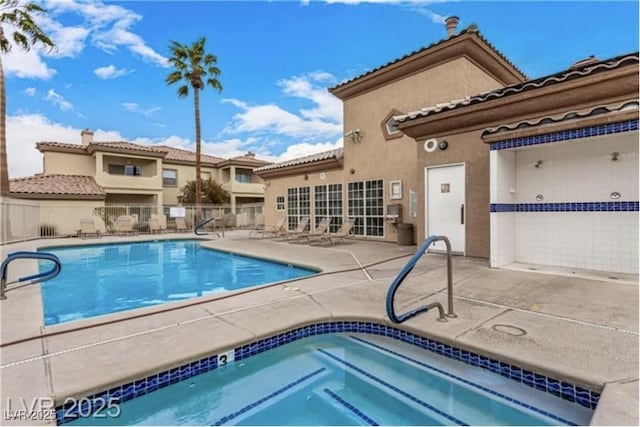 6901 Cobre Azul Ave Unit 202, Las Vegas, NV 89108 - community pool featuring a hot tub, a patio, and fence