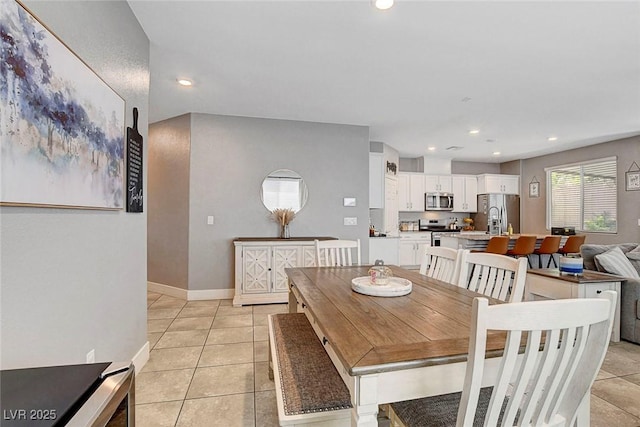 dining room with light tile patterned floors and recessed lighting