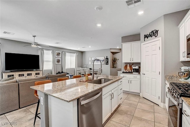 kitchen featuring a sink, appliances with stainless steel finishes, light tile patterned flooring, and visible vents