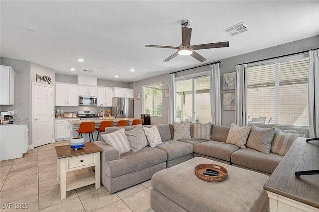living room with visible vents, recessed lighting, ceiling fan, and light tile patterned floors