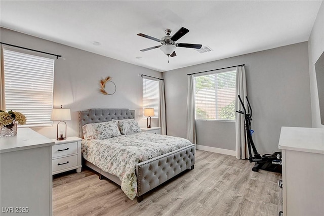 bedroom featuring a ceiling fan, baseboards, visible vents, and light wood-type flooring