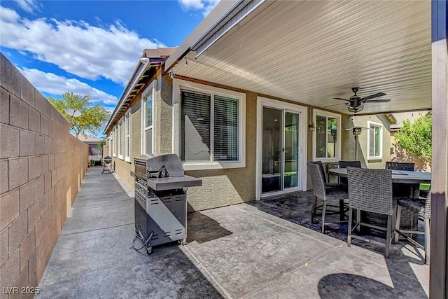 view of patio / terrace featuring a fenced backyard, a ceiling fan, grilling area, and outdoor dining space