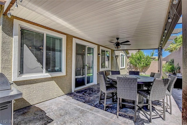 view of patio with outdoor dining space and ceiling fan