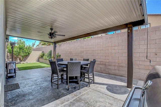 view of patio / terrace featuring a fenced backyard, a ceiling fan, and outdoor dining area