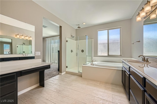 full bath featuring a garden tub, tile patterned floors, a stall shower, and vanity