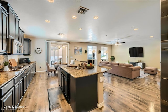 kitchen featuring visible vents, light wood-type flooring, a healthy amount of sunlight, and stainless steel appliances