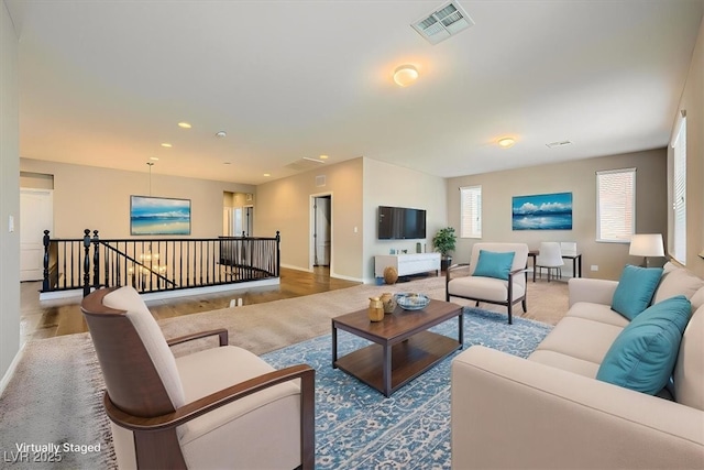 living room with visible vents, recessed lighting, baseboards, and wood finished floors