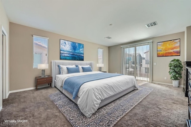 carpeted bedroom with access to outside, baseboards, and visible vents
