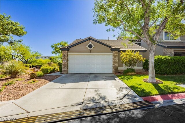 504 Painted Cloud Pl, Las Vegas, NV 89144 - view of front of house with concrete driveway, an attached garage, stone siding, and a front yard