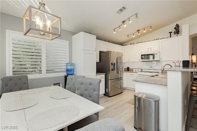 504 Painted Cloud Pl, Las Vegas, NV 89144 - kitchen with white appliances, a sink, lofted ceiling, white cabinets, and light wood-style floors