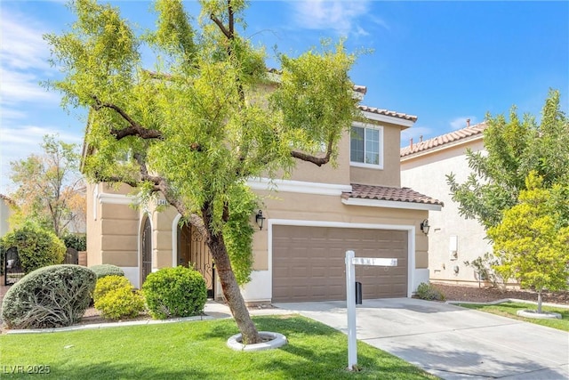 mediterranean / spanish house with an attached garage, stucco siding, driveway, and a front yard
