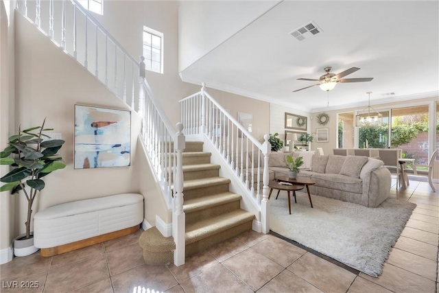 stairs with baseboards, tile patterned flooring, a ceiling fan, and visible vents