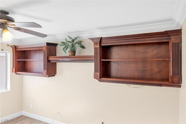 room details with baseboards, ornamental molding, and a ceiling fan