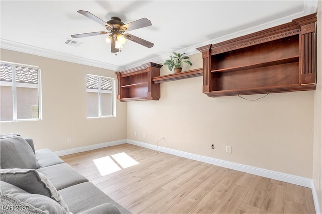 unfurnished living room featuring a ceiling fan, visible vents, light wood-type flooring, baseboards, and ornamental molding