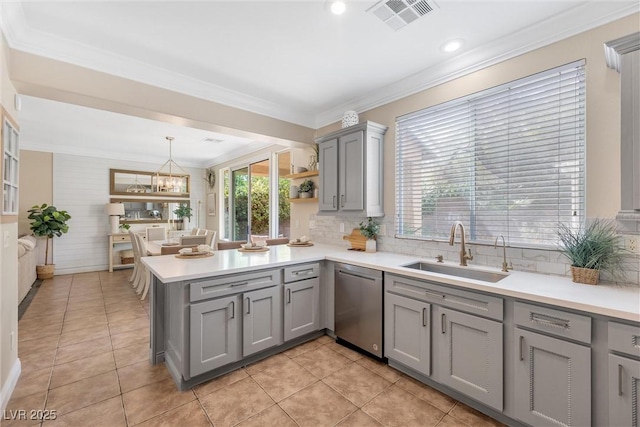 kitchen featuring gray cabinets, visible vents, dishwasher, a sink, and a peninsula