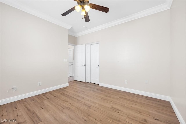 unfurnished room featuring baseboards, ornamental molding, light wood-style floors, and ceiling fan