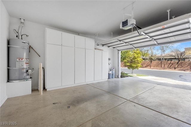 garage with a garage door opener and strapped water heater