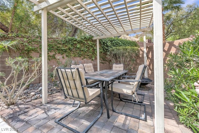 view of patio with outdoor dining area, a fenced backyard, and a pergola