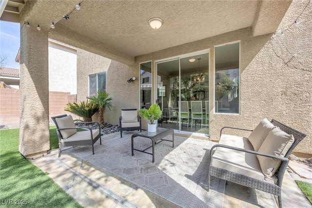 view of patio / terrace featuring fence and an outdoor hangout area
