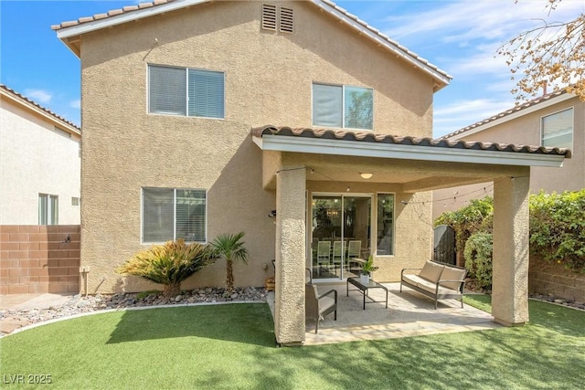 rear view of house featuring fence, a patio, and stucco siding