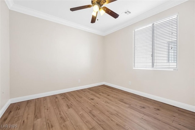 unfurnished room with crown molding, baseboards, and visible vents