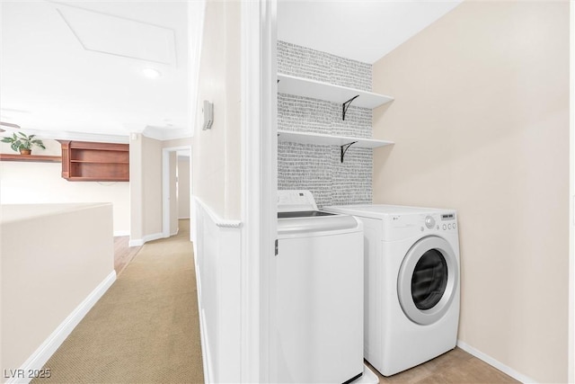 laundry room with laundry area, baseboards, and washing machine and dryer