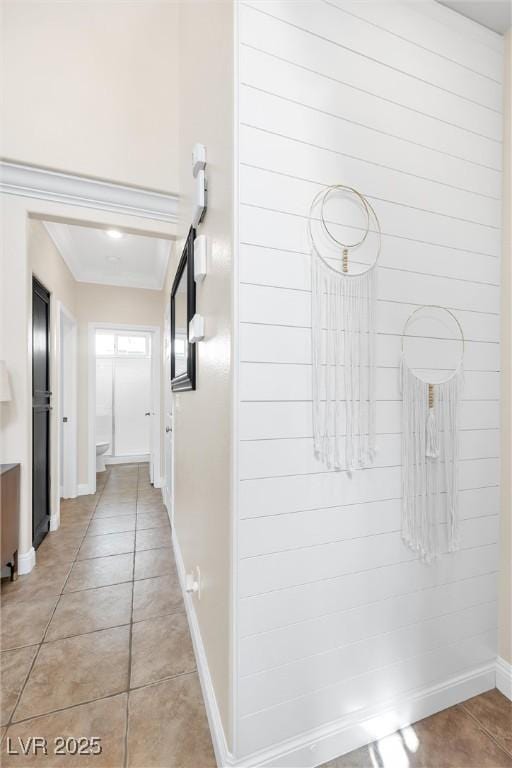 hallway with baseboards and light tile patterned flooring
