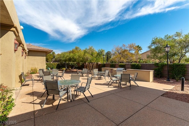 view of patio with fence and outdoor dining space