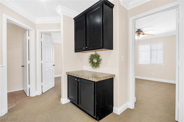 hallway with baseboards, light carpet, and ornamental molding