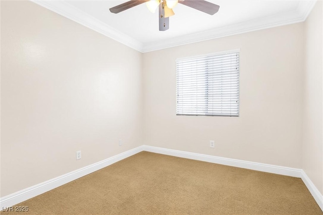 spare room with baseboards, a ceiling fan, carpet, and ornamental molding