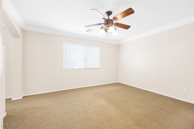 unfurnished room with crown molding, ceiling fan, baseboards, and carpet