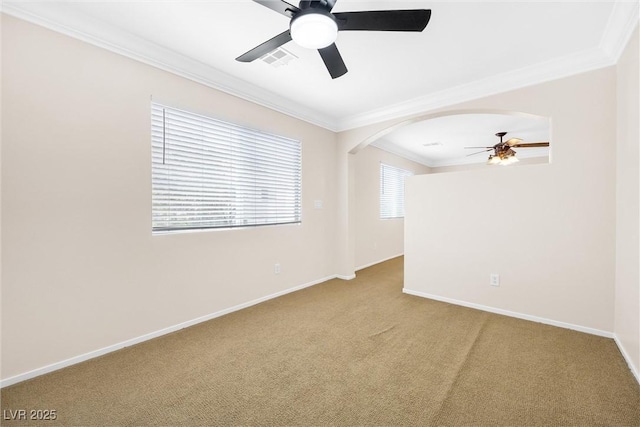 unfurnished room featuring ceiling fan, visible vents, ornamental molding, carpet flooring, and a wealth of natural light