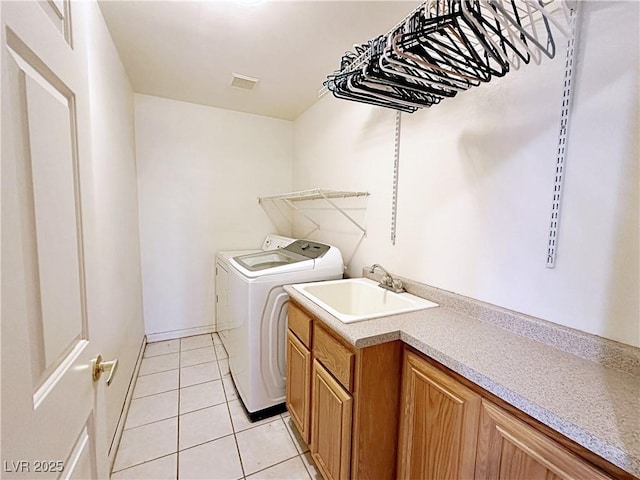 5704 Burdel St, Las Vegas, NV 89149 - laundry room featuring a sink, light tile patterned floors, and washing machine and dryer