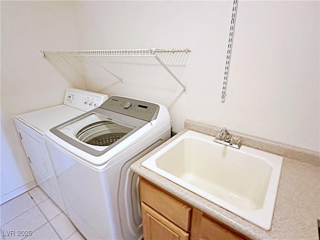 5704 Burdel St, Las Vegas, NV 89149 - clothes washing area with a sink, light tile patterned floors, cabinet space, and washer and clothes dryer