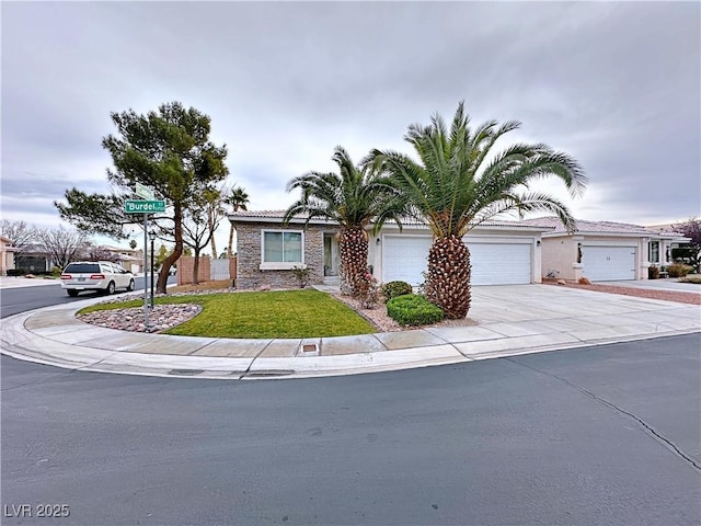 5704 Burdel St, Las Vegas, NV 89149 - view of front of home with an attached garage, driveway, stone siding, and a front yard
