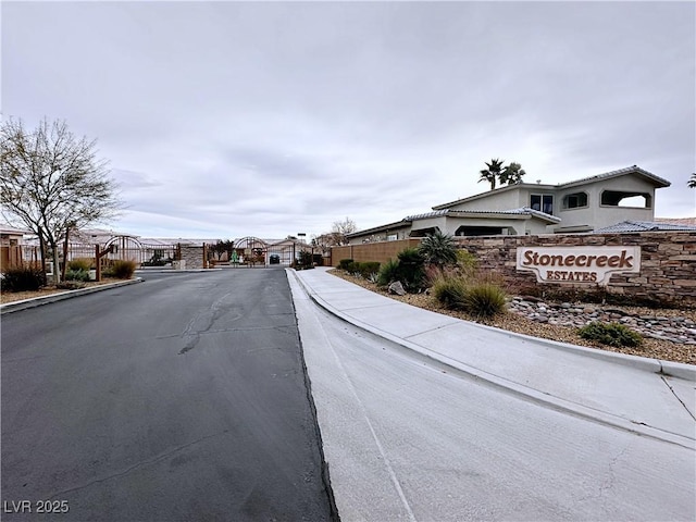 5704 Burdel St, Las Vegas, NV 89149 - view of road with a gate, a gated entry, curbs, and sidewalks