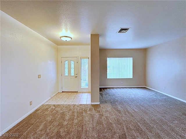 5704 Burdel St, Las Vegas, NV 89149 - foyer entrance with tile patterned flooring, a textured ceiling, carpet, baseboards, and visible vents