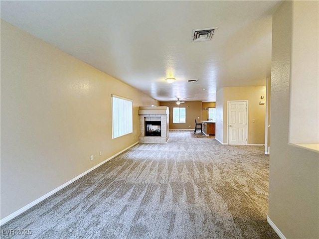 5704 Burdel St, Las Vegas, NV 89149 - unfurnished living room with visible vents, carpet, baseboards, and a tile fireplace