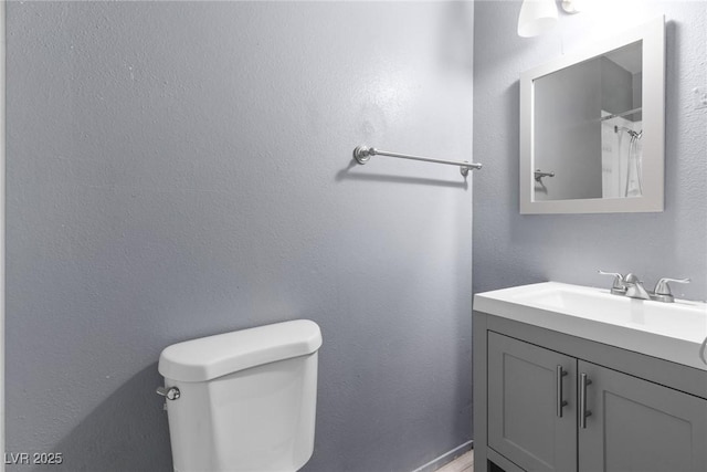 bathroom featuring vanity, a shower with curtain, and toilet