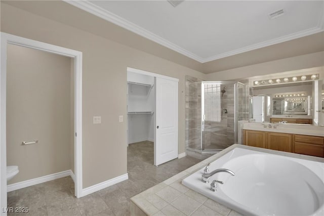 bathroom featuring crown molding, vanity, a walk in closet, a bath, and a stall shower