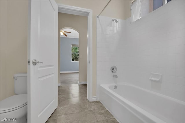 full bathroom with toilet, baseboards, tub / shower combination, and tile patterned flooring