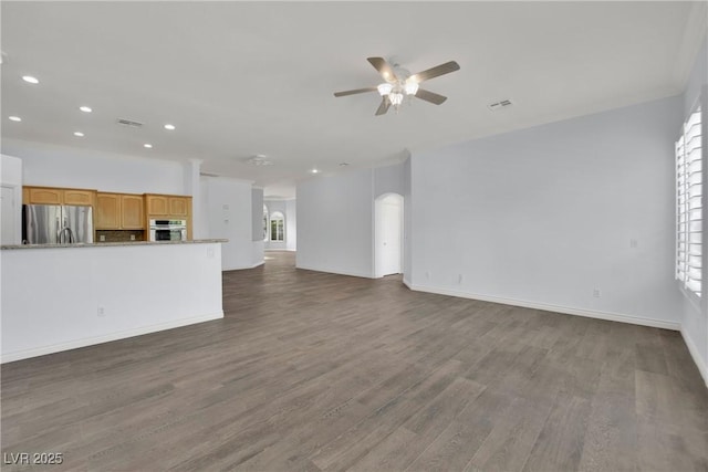 unfurnished living room featuring ceiling fan, visible vents, wood finished floors, baseboards, and recessed lighting