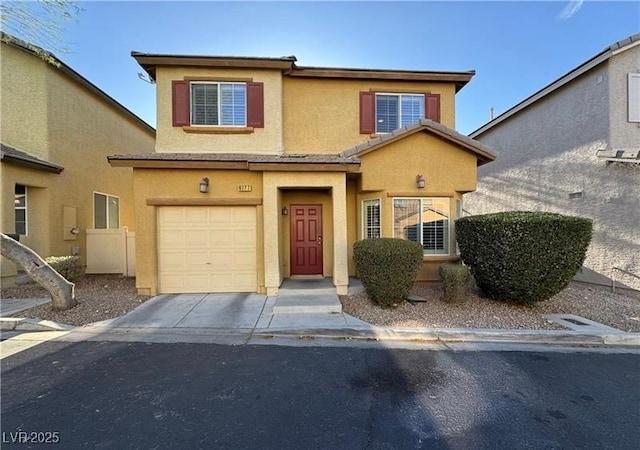 view of front of home featuring an attached garage, stucco siding, and concrete driveway