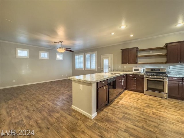 kitchen featuring stainless steel range with gas cooktop, dishwasher, crown molding, a sink, and light wood-type flooring