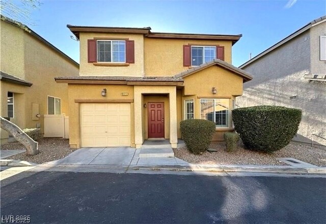 6777 Wormwood Ln, Las Vegas, NV 89148 - view of front facade with stucco siding, an attached garage, and concrete driveway
