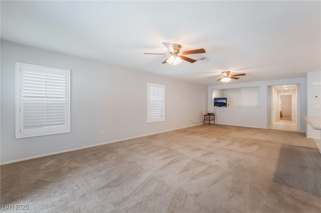 4436 Hatch Bend Ave, North Las Vegas, NV 89031 - unfurnished living room featuring a ceiling fan, baseboards, visible vents, and light carpet