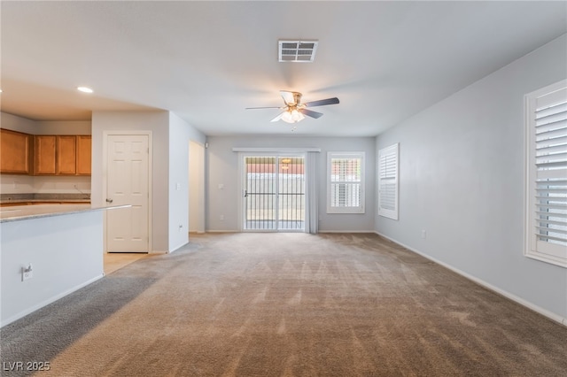 4436 Hatch Bend Ave, North Las Vegas, NV 89031 - unfurnished living room featuring baseboards, ceiling fan, visible vents, and light colored carpet