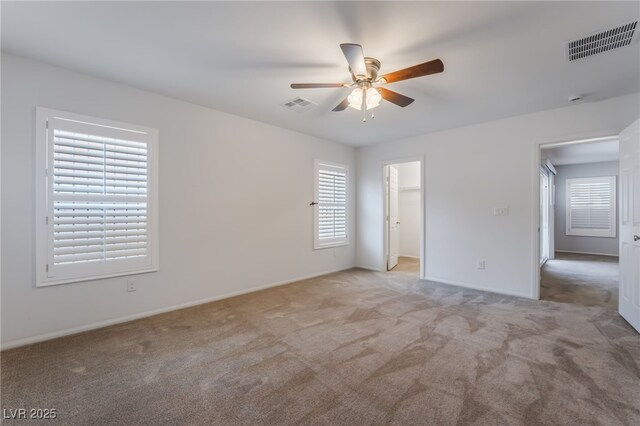 4436 Hatch Bend Ave, North Las Vegas, NV 89031 - unfurnished bedroom with baseboards, a walk in closet, light colored carpet, and visible vents