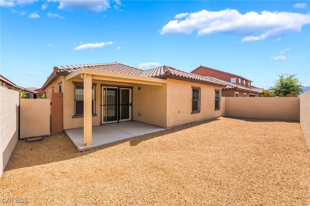 4436 Hatch Bend Ave, North Las Vegas, NV 89031 - rear view of property with a fenced backyard, stucco siding, a patio area, and a tile roof